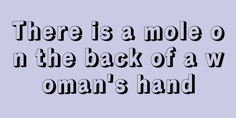 There is a mole on the back of a woman's hand