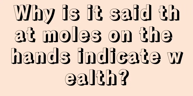 Why is it said that moles on the hands indicate wealth?