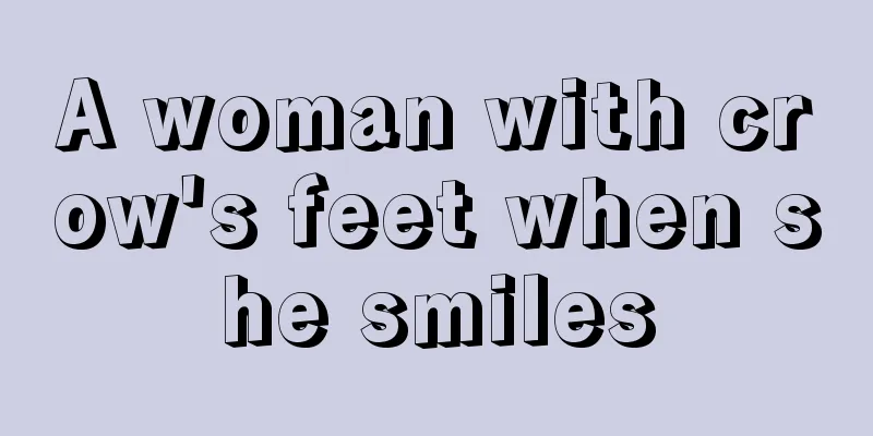A woman with crow's feet when she smiles